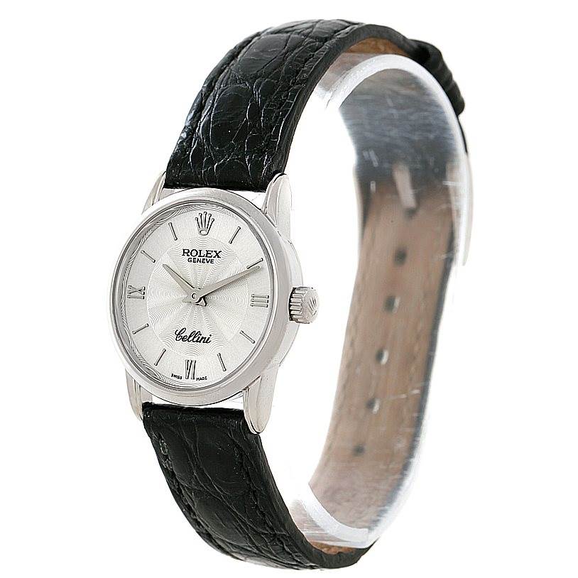 The image shows a side-angle view of the Rolex Cellini 6111 Women's White Gold Silver Dial 6111 Women's White Gold Silver Dial watch, displaying its dial, crown, and black leather strap.