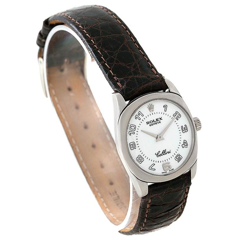 This Rolex Cellini 6229 Women's White Gold White Dial 6229 Women's White Gold White Dial watch is shown at a three-quarter angle, highlighting its leather strap, dial, case, and crown.
