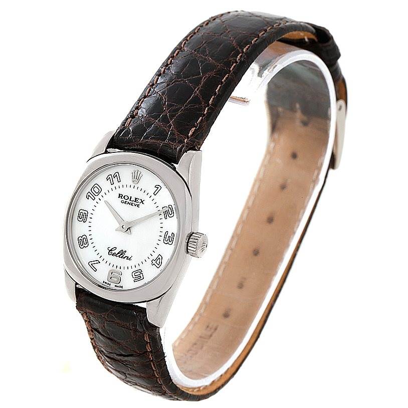 The image shows a Rolex Cellini 6229 Women's White Gold White Dial 6229 Women's White Gold White Dial watch angled to display the face, crown, and leather strap.