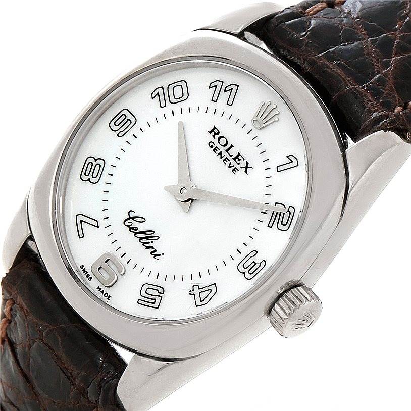 The image shows a close-up view of a Rolex Cellini 6229 Women's White Gold White Dial 6229 Women's White Gold White Dial watch, displaying its dial, hands, crown, and part of the leather strap.