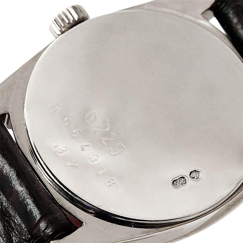 The image shows the back case, crown, and part of the strap of the Rolex Cellini 6229 Women's White Gold White Dial 6229 Women's White Gold White Dial watch.