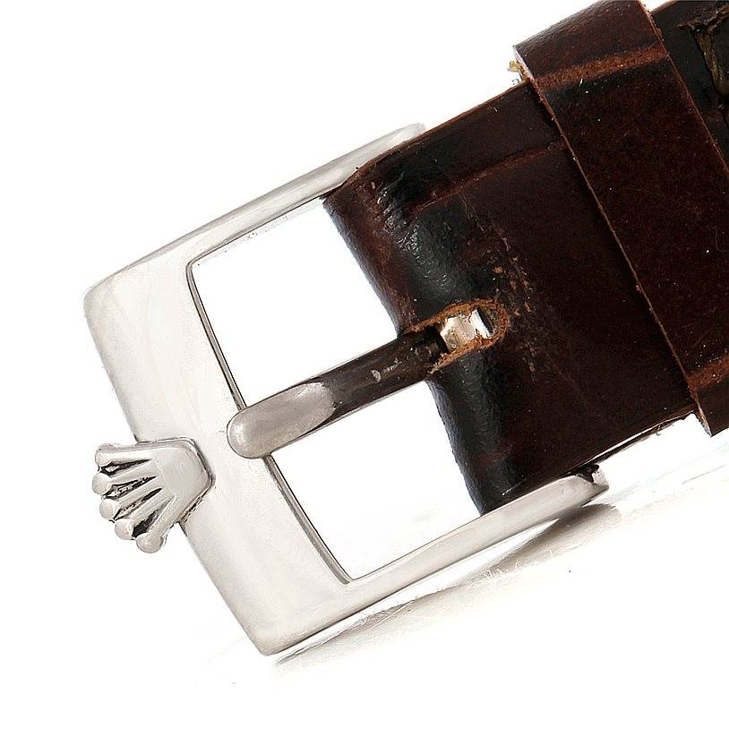 The image shows a close-up of the buckle and part of the leather strap of a Rolex Cellini 6229 Women's White Gold White Dial 6229 Women's White Gold White Dial watch.