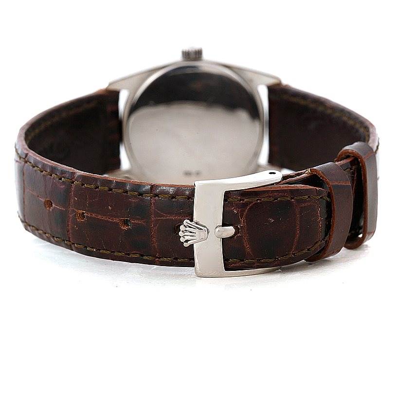 The image shows the back of a Rolex Cellini 6229 Women's White Gold White Dial 6229 Women's White Gold White Dial watch, highlighting the leather strap and buckle with the Rolex logo.