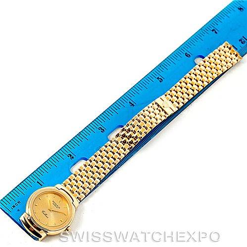 The image shows a Rolex Cellini 6621 Women's Yellow Gold Champagne Dial 6621 Women's Yellow Gold Champagne Dial watch laid flat alongside a ruler, displaying the watch face and entirety of the band.