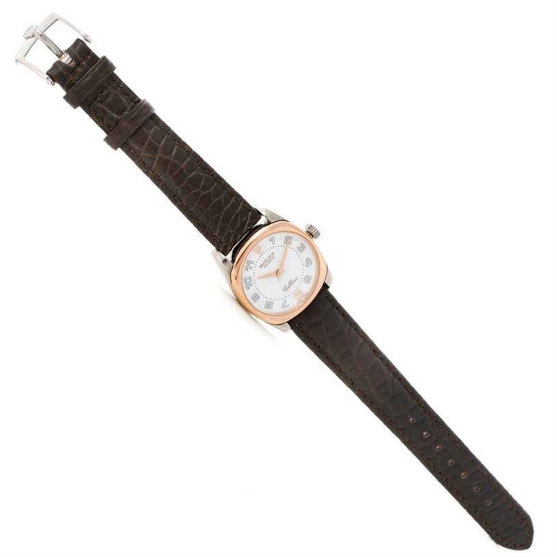 The image shows an overhead view of a Rolex Cellini 6229 Women's White Gold White Dial 6229 Women's White Gold White Dial watch, featuring the face, case, crown, and leather strap.