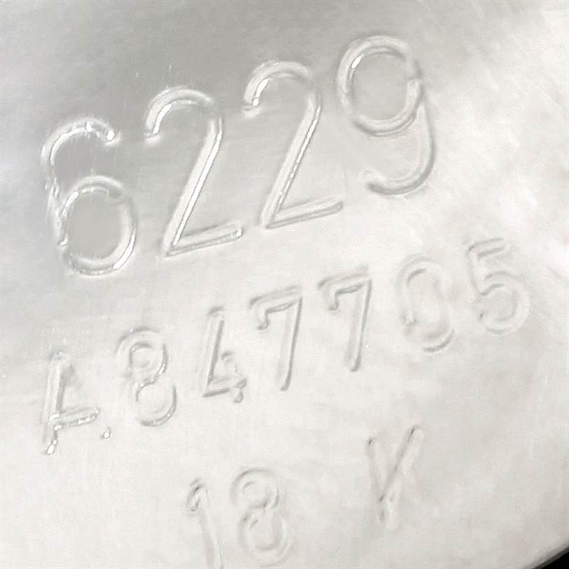 The image shows the engraved serial numbers on the back casing of a Rolex Cellini 6229 Women's White Gold White Dial 6229 Women's White Gold White Dial watch model.