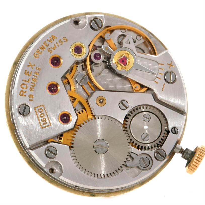 The image shows the internal mechanism of a Rolex Cellini 3810 Women's Yellow Gold Champagne Dial 3810 Women's Yellow Gold Champagne Dial watch, highlighting gears, screws, and the winding crown from a top-down angle.
