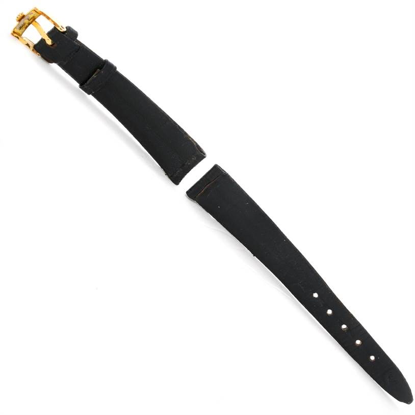 This image shows a black leather strap and gold buckle of a Rolex Cellini 3810 Women's Yellow Gold Champagne Dial 3810 Women's Yellow Gold Champagne Dial watch from a top-down angle.