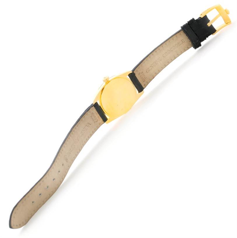 The image shows an overhead view of a Rolex Cellini 6229 Women's Yellow Gold Black Dial 6229 Women's Yellow Gold Black Dial watch, displaying the case back, crown, and leather strap.