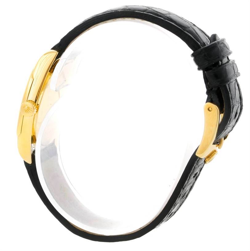 The image shows a side view of a Rolex Cellini 6229 Women's Yellow Gold Black Dial 6229 Women's Yellow Gold Black Dial watch, highlighting its gold case, crown, and black leather strap with a buckle.