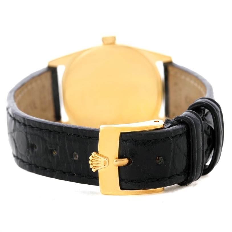 The image shows the back of a Rolex Cellini 6229 Women's Yellow Gold Black Dial 6229 Women's Yellow Gold Black Dial watch, focusing on its black leather strap and gold buckle.