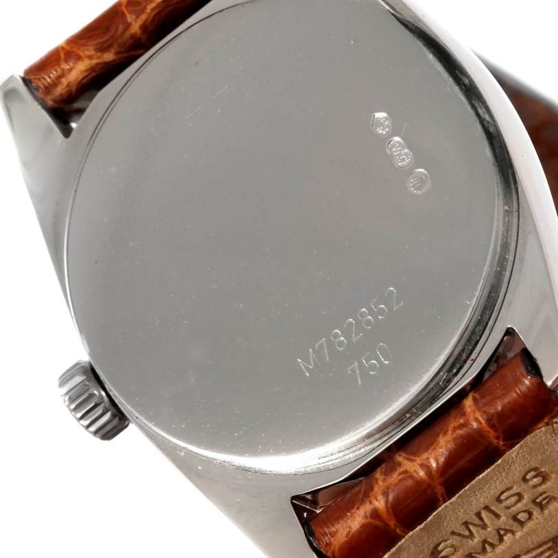 The image shows the backside and part of the strap of a Rolex Cellini 6229 Women's White Gold White Dial 6229 Women's White Gold White Dial model watch, highlighting the caseback and engravings.