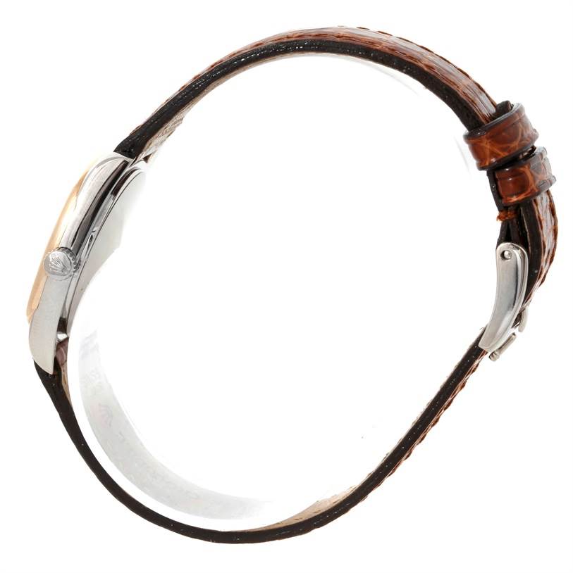 The image shows a side view of a Rolex Cellini 6229 Women's White Gold White Dial 6229 Women's White Gold White Dial watch, highlighting the crown, case, and brown leather strap with buckle.