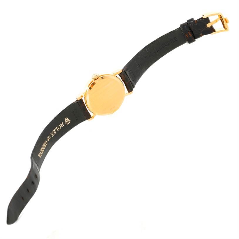 This image shows the back view of the Rolex Cellini 5113 Women's Yellow Gold Champagne Dial 5113 Women's Yellow Gold Champagne Dial watch, highlighting the case and black leather strap with the branded buckle.