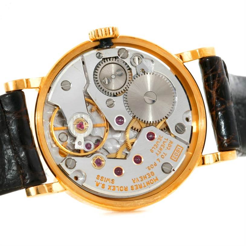 The image shows the back of the Rolex Cellini 5113 Women's Yellow Gold Champagne Dial 5113 Women's Yellow Gold Champagne Dial watch, highlighting its inner mechanical parts and movement.