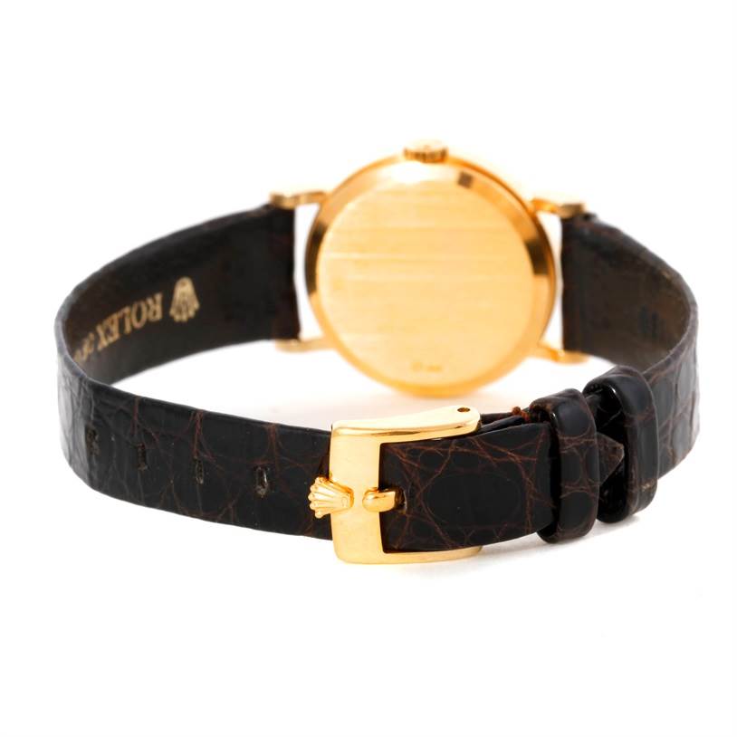 The image shows the back case and clasp side of a Rolex Cellini 5113 Women's Yellow Gold Champagne Dial 5113 Women's Yellow Gold Champagne Dial watch, highlighting the leather strap and gold buckle.