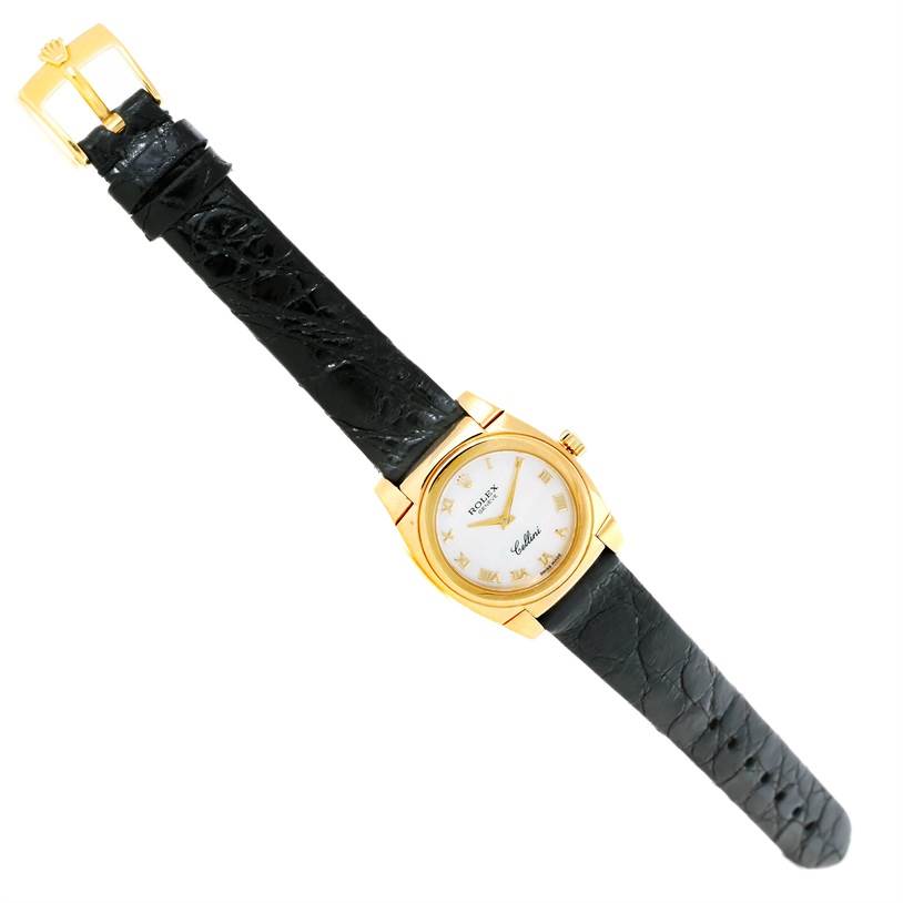 The image shows a Rolex Cellini 5310 Women's Yellow Gold Mother of Pearl Dial 5310 Women's Yellow Gold Mother of Pearl Dial watch from an angled top-down perspective, highlighting its black leather strap and gold case.