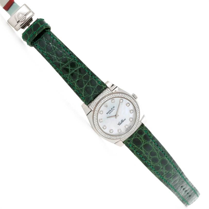 The image shows a Rolex Cellini 6321 Women's White Gold Mother of Pearl Dial 6321 Women's White Gold Mother of Pearl Dial watch from a top-down angle, displaying the green leather strap and white diamond-studded dial.