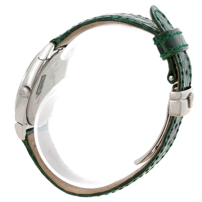 The image shows the side view of a Rolex Cellini 6321 Women's White Gold Mother of Pearl Dial 6321 Women's White Gold Mother of Pearl Dial watch, featuring the bezel, crown, and green leather strap.