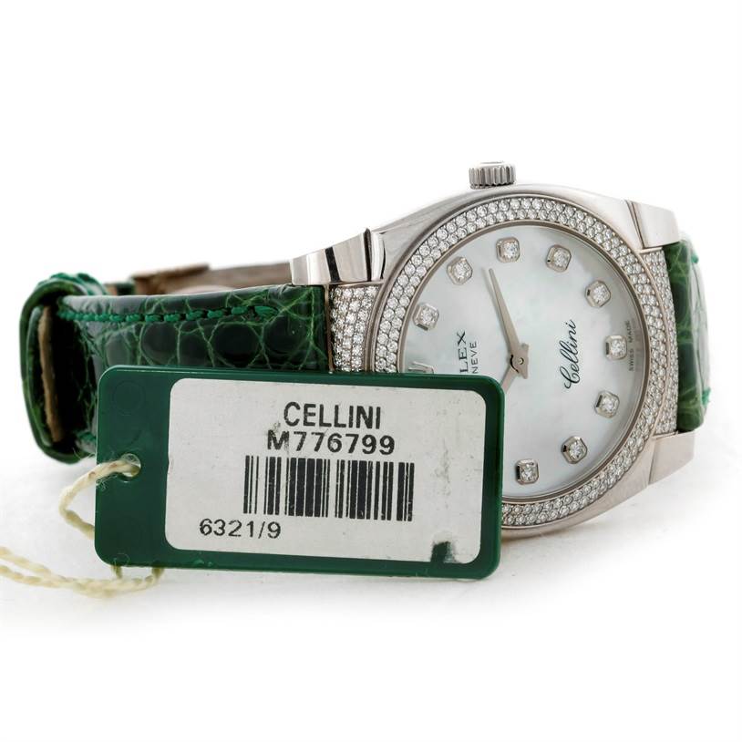 The image shows a side view of the Rolex Cellini 6321 Women's White Gold Mother of Pearl Dial 6321 Women's White Gold Mother of Pearl Dial watch, highlighting its green strap, diamond-studded bezel, and identification tag.