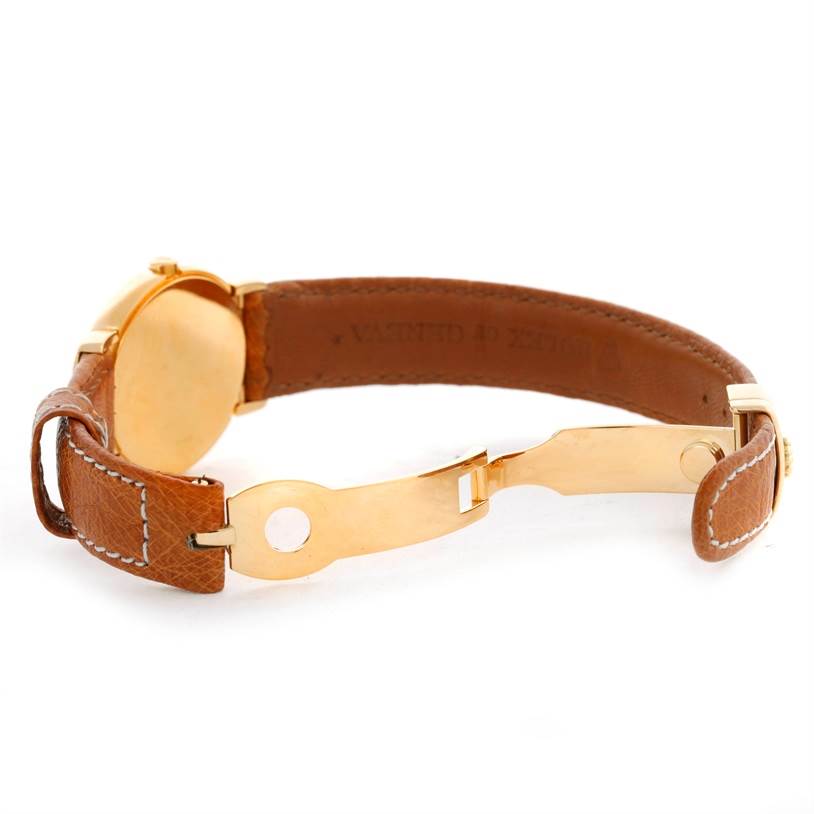 The Rolex Cellini 6621 Women's Yellow Gold Champagne Dial 6621 Women's Yellow Gold Champagne Dial watch is shown at an angle displaying the back of the case and the partially opened brown leather strap with gold clasp.