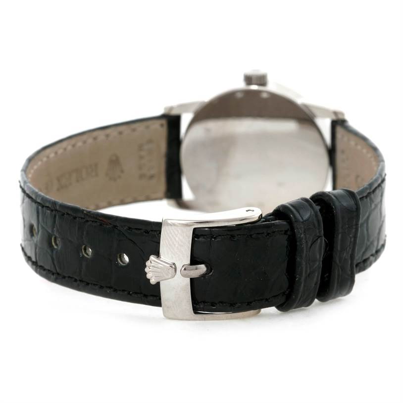 The image shows the back view of a Rolex Cellini 6111 Women's White Gold Silver Dial 6111 Women's White Gold Silver Dial watch, emphasizing the black leather strap and clasp.