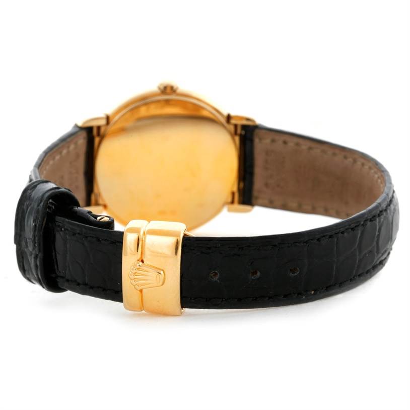 The image shows the rear view of a Rolex Cellini 6621 Women's Yellow Gold White Dial 6621 Women's Yellow Gold White Dial watch, highlighting the gold clasp and black leather strap.