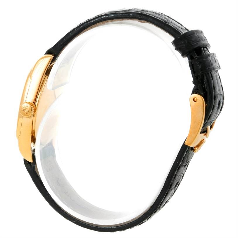 The Rolex Cellini 6229 Women's Yellow Gold White Dial 6229 Women's Yellow Gold White Dial watch is shown in a side profile angle, displaying its black leather strap and gold casing.