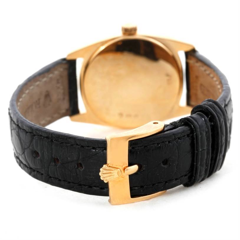 The image shows the back side of a Rolex Cellini 6229 Women's Yellow Gold White Dial 6229 Women's Yellow Gold White Dial watch, highlighting the black leather strap and gold buckle with the Rolex logo.