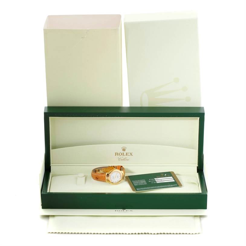 The image shows a Rolex Cellini 6621 Women's Yellow Gold White Dial 6621 Women's Yellow Gold White Dial watch in its open case with accompanying warranty card and outer box.