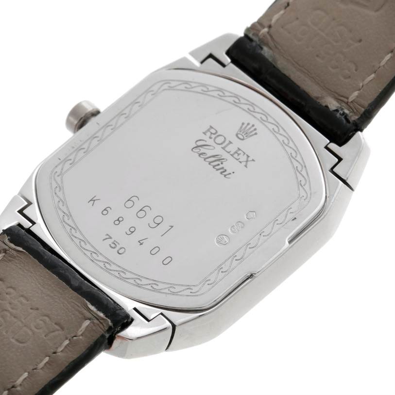 The image shows the backside of the Rolex Cellini 6691 Women's White Gold Mother of Pearl Dial 6691 Women's White Gold Mother of Pearl Dial watch, featuring its case back, crown, and part of the leather strap.
