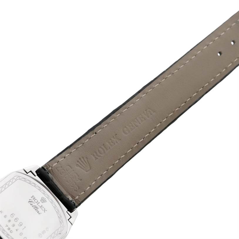 The image shows a close-up of the back of the Rolex Cellini 6691 Women's White Gold Mother of Pearl Dial 6691 Women's White Gold Mother of Pearl Dial watch and its leather strap with "Rolex Geneva" engraving.