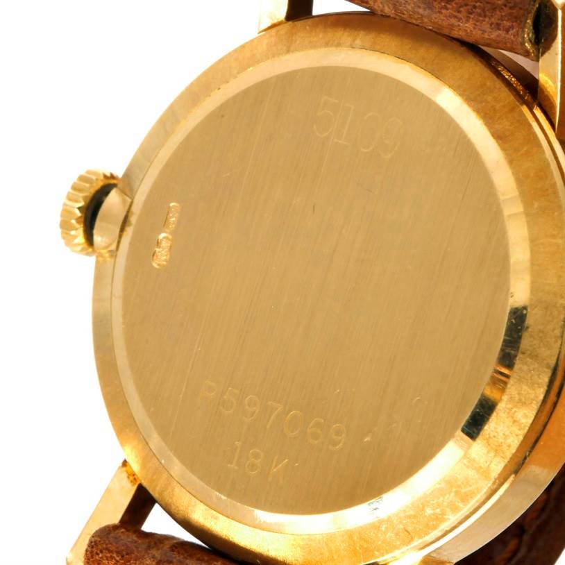 The image shows the back case and crown of a Rolex Cellini 5109 Women's Yellow Gold Champagne Dial 5109 Women's Yellow Gold Champagne Dial watch with the leather strap attachments visible.