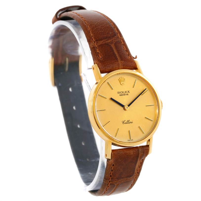 This Rolex Cellini 5109 Women's Yellow Gold Champagne Dial 5109 Women's Yellow Gold Champagne Dial watch is shown at a slightly angled side view, featuring the gold dial, brown leather strap, and minimalist face design.