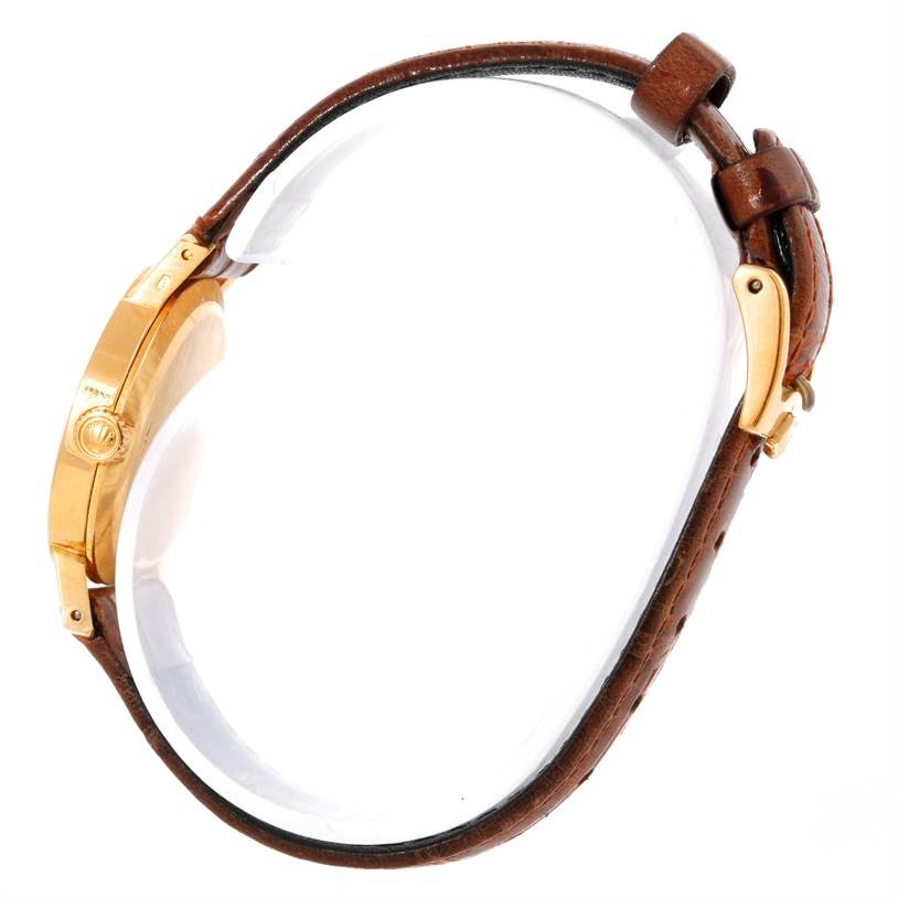 This image shows a side view of the Rolex Cellini 5109 Women's Yellow Gold Champagne Dial 5109 Women's Yellow Gold Champagne Dial watch, highlighting its gold case and brown leather strap.