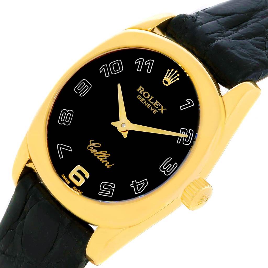 The Rolex Cellini 6229 Women's Yellow Gold Black Dial 6229 Women's Yellow Gold Black Dial watch is shown from an angled front view, highlighting its face, crown, and part of the leather strap.