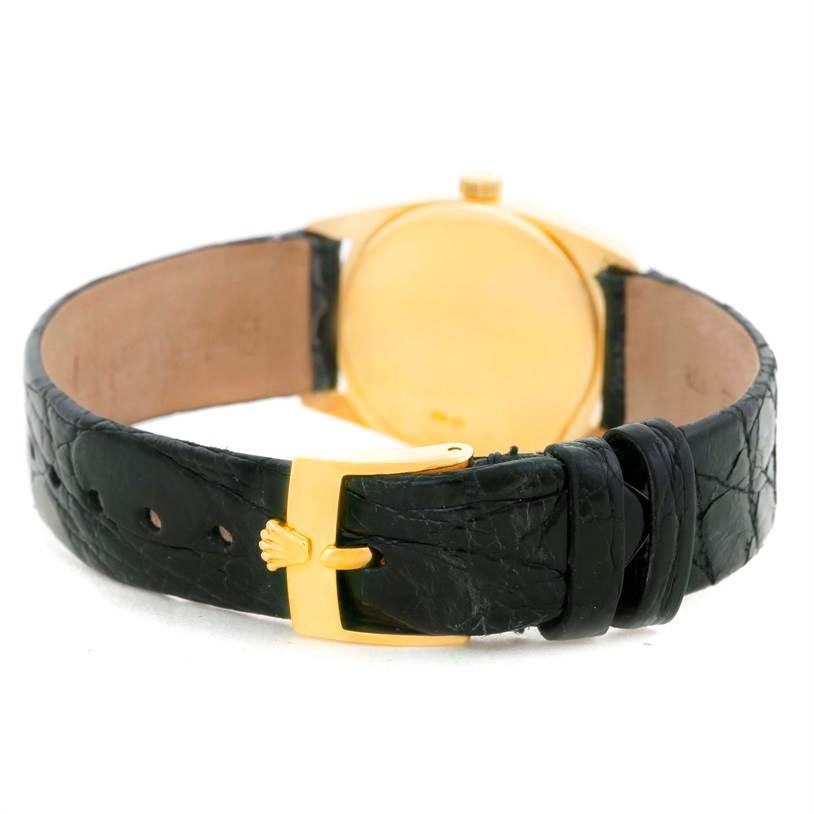 The image shows the back view of a Rolex Cellini 6229 Women's Yellow Gold Black Dial 6229 Women's Yellow Gold Black Dial watch with a black leather strap and a gold clasp.