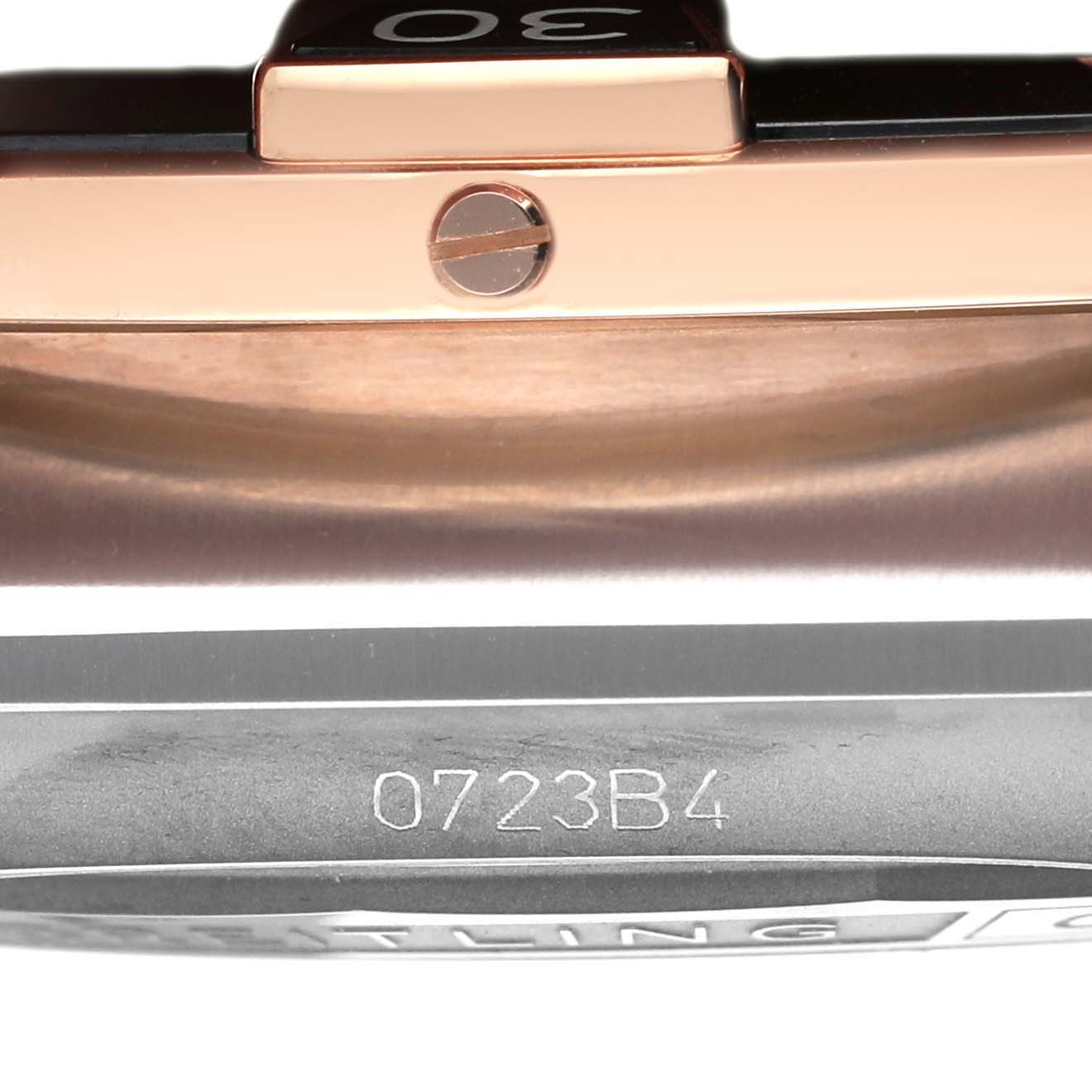 This close-up image shows the side view of a Breitling Chronomat UB0136 Men's Stainless Steel Green Dial UB0136 Men's Stainless Steel Green Dial watch, highlighting the bezel and part of the case with the serial number.