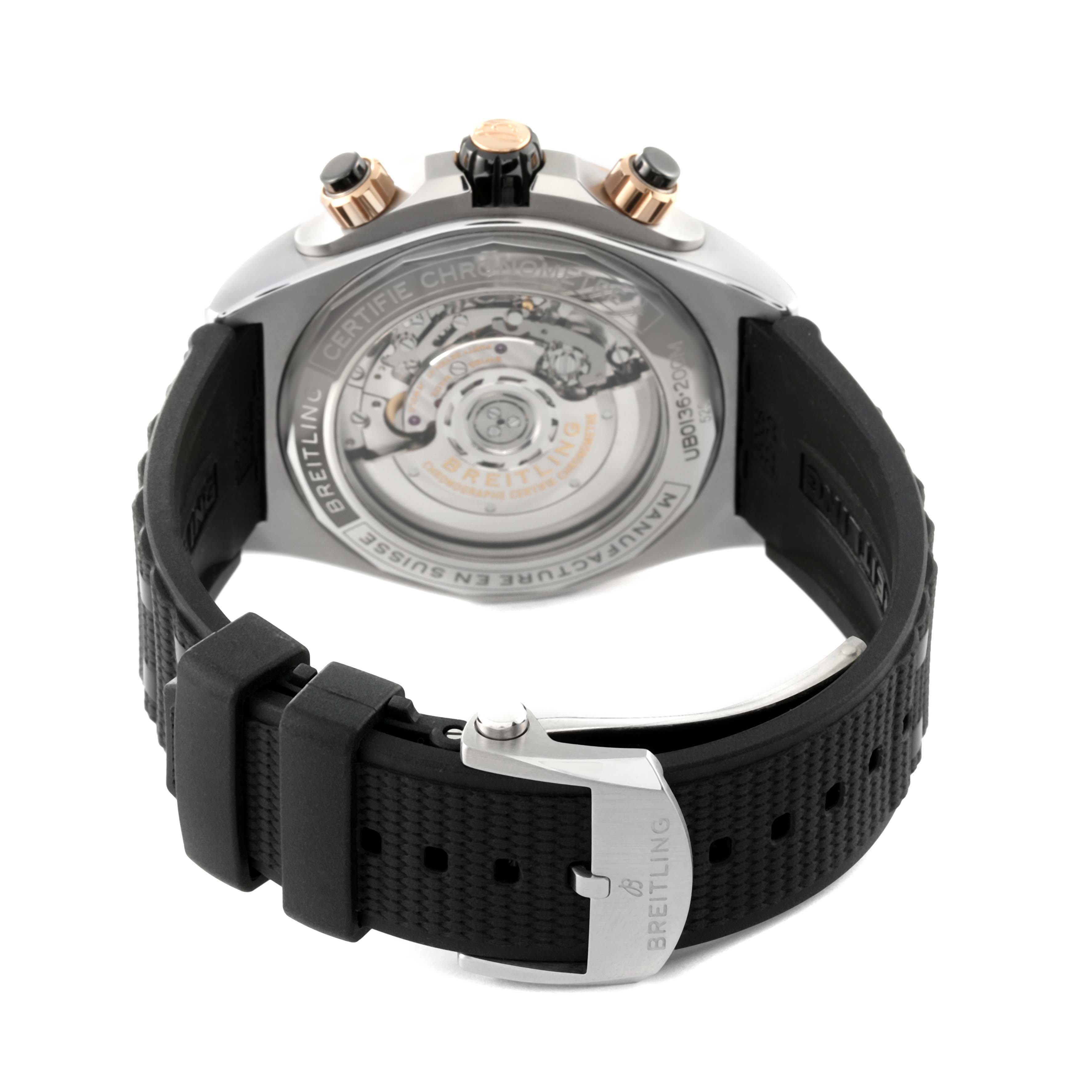 The image shows the back view of a Breitling Chronomat UB0136 Men's Stainless Steel Green Dial UB0136 Men's Stainless Steel Green Dial watch, highlighting the movement and black strap.