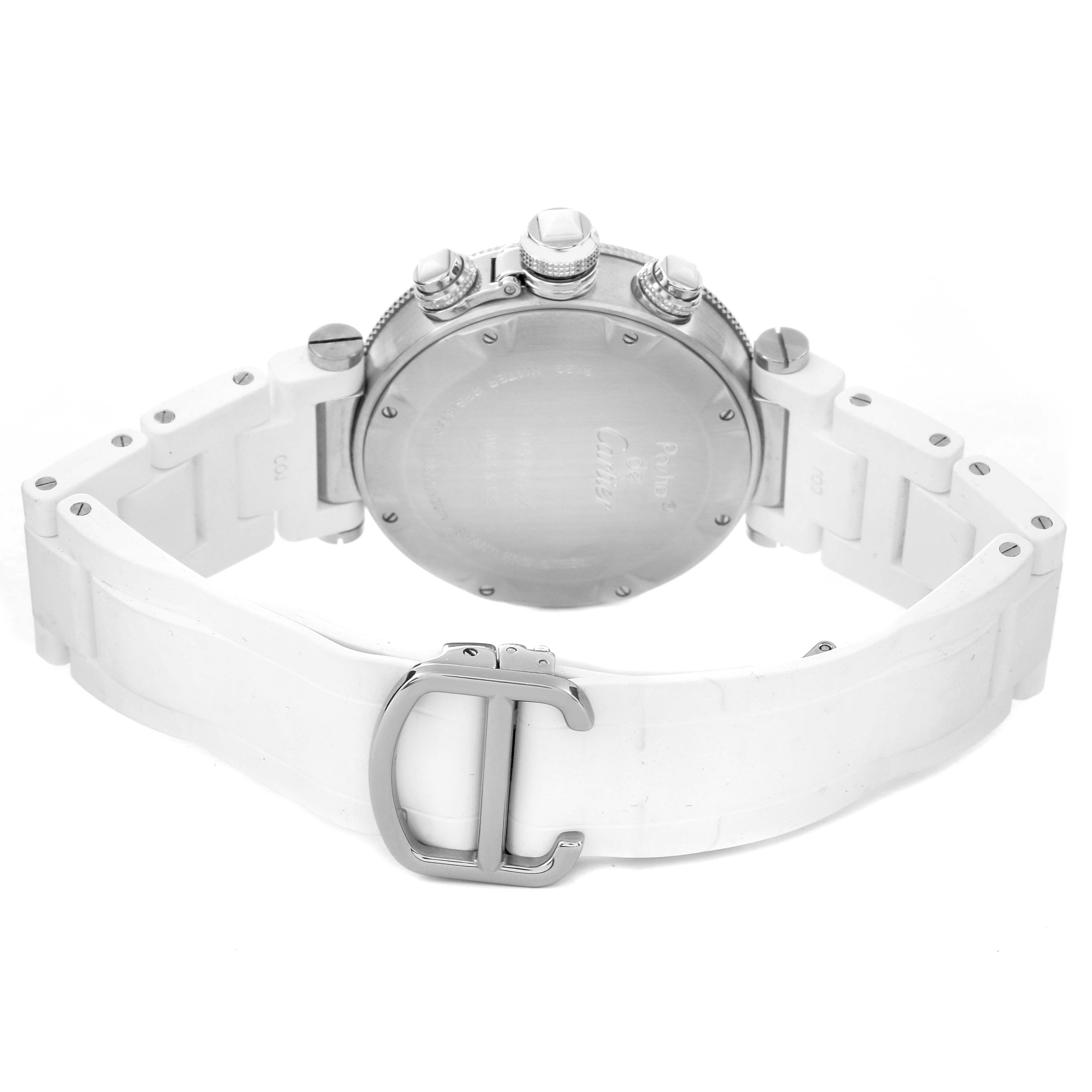 The image shows the back view of a Pasha model by Cartier, highlighting the case back, crown, and white strap with a clasp.