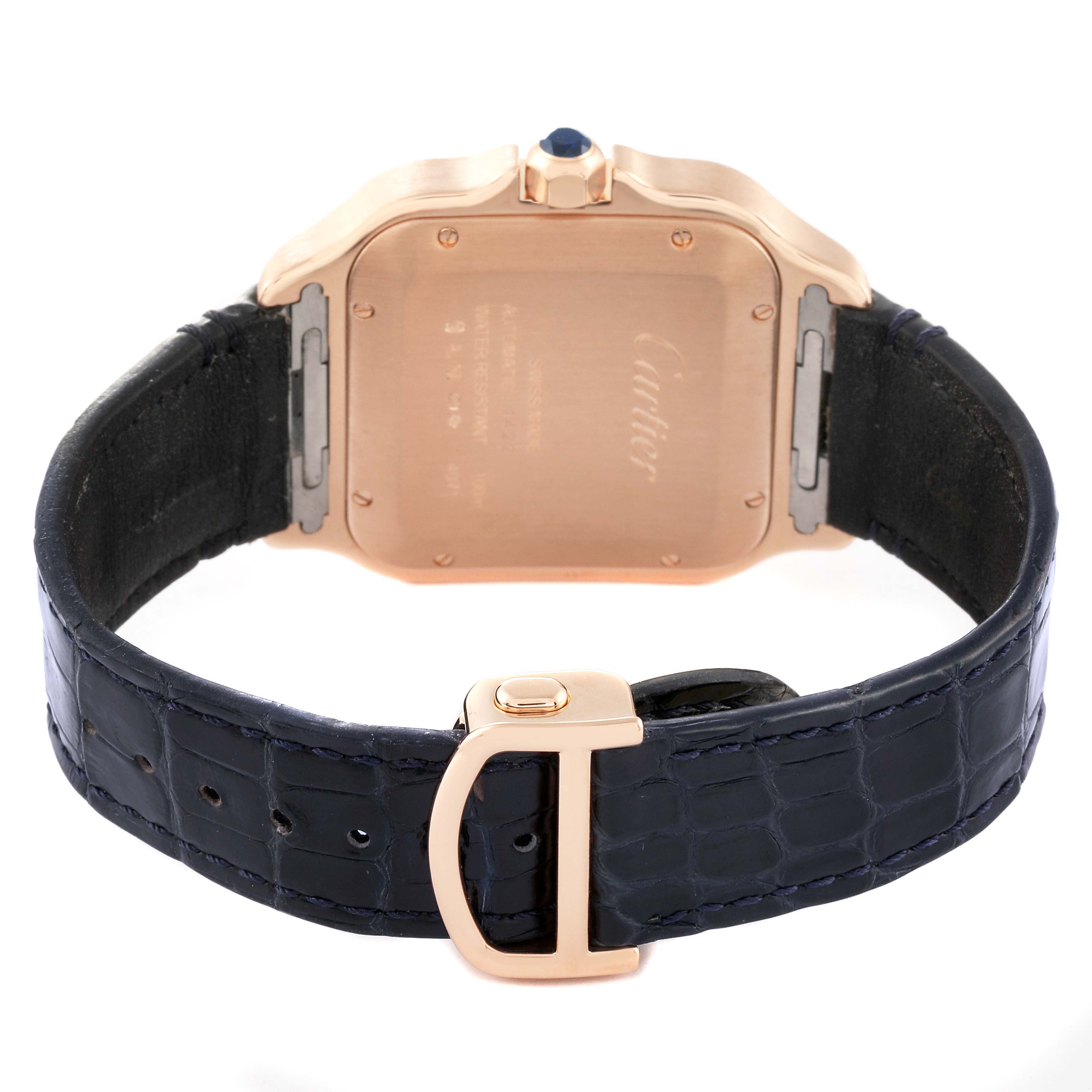 The image shows the back of a Santos model watch by Cartier, highlighting the strap and caseback details.