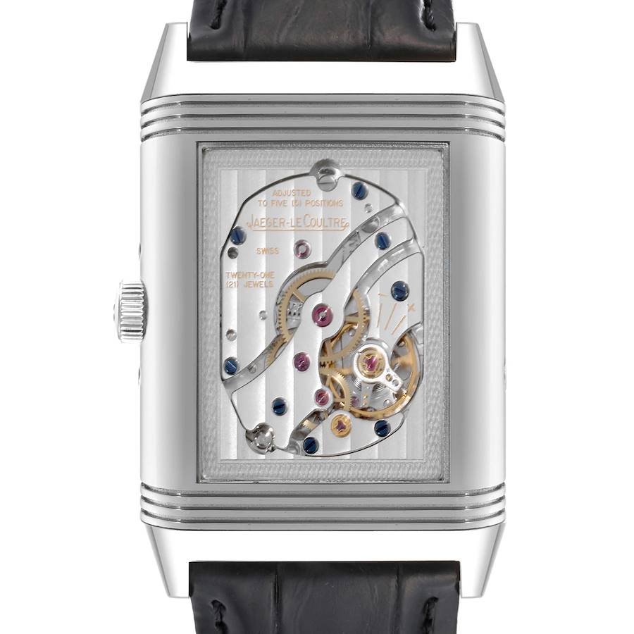 The image shows the back view of the Jaeger-LeCoultre Reverso watch, highlighting its intricate mechanical movement.