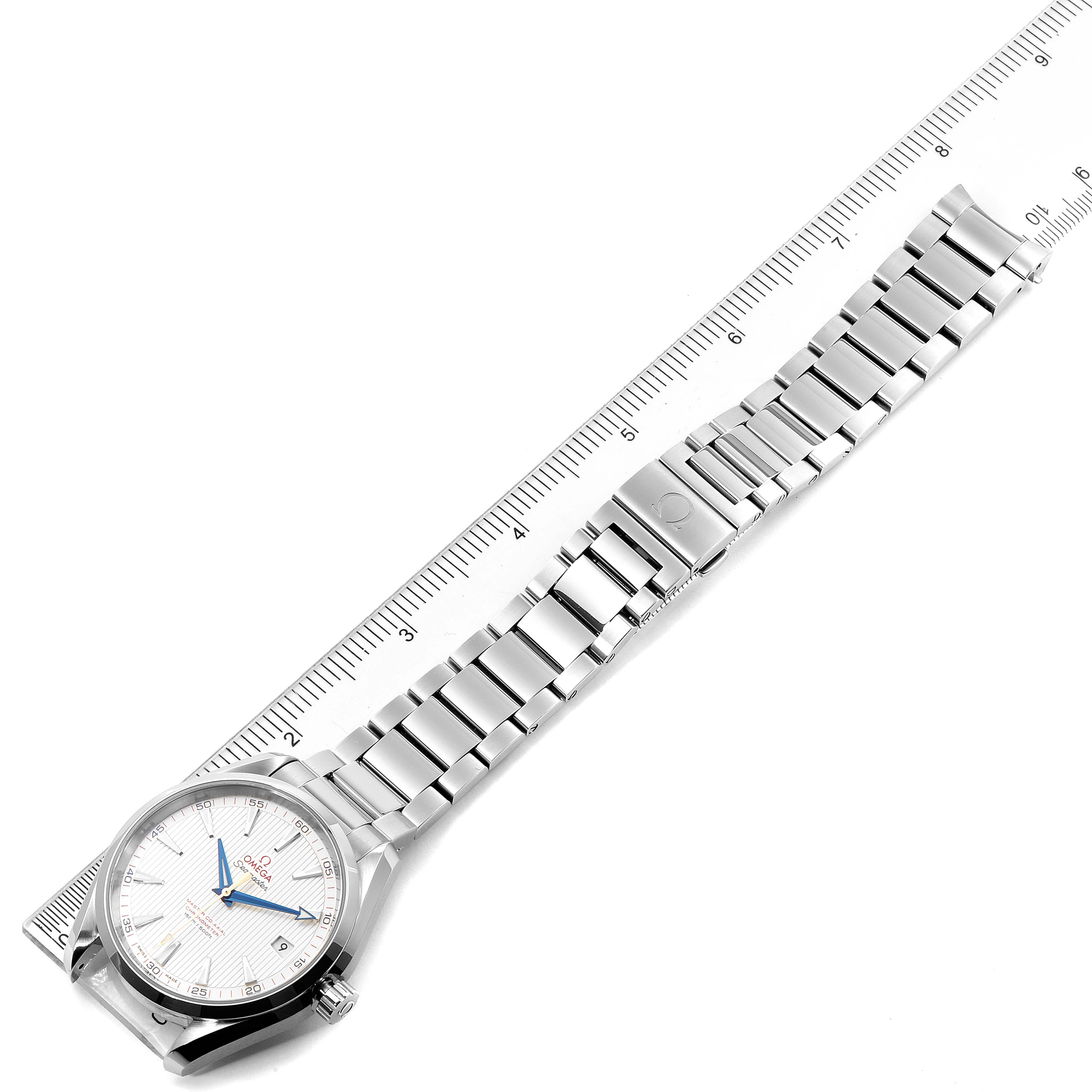 The image shows an Omega Aqua Terra 231.10.42.21.02.004 Men
s Stainless Steel Silver Dial 231.10.42.21.02.004 Men
s Stainless Steel Silver Dial watch laid flat, positioned diagonally, with a metal bracelet extended and measured by a ruler.