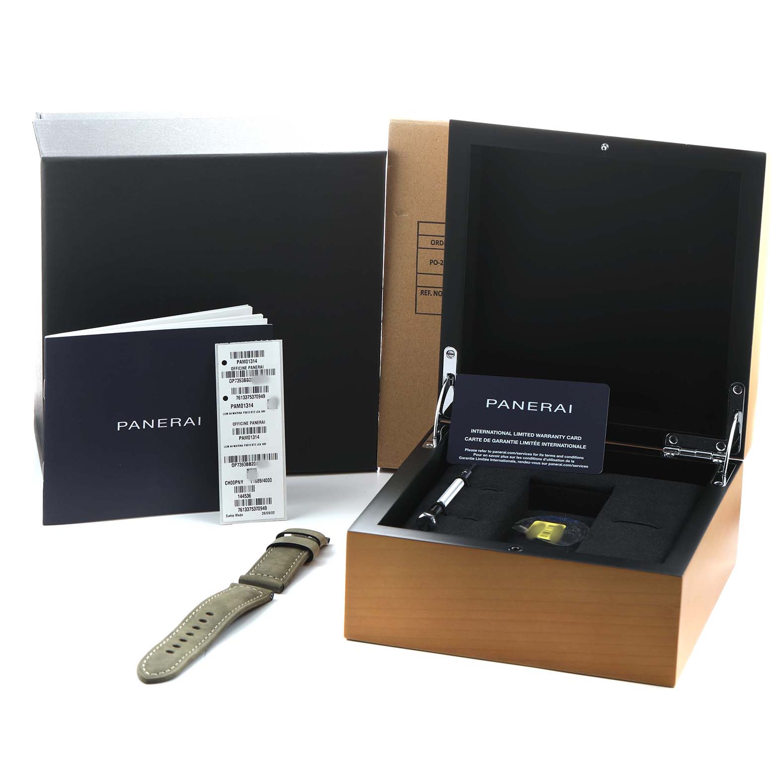 The Panerai Luminor PAM01314 Men's Stainless Steel White Dial watch accessories are shown from a front angle, including a box, a strap, manuals, and warranty card.