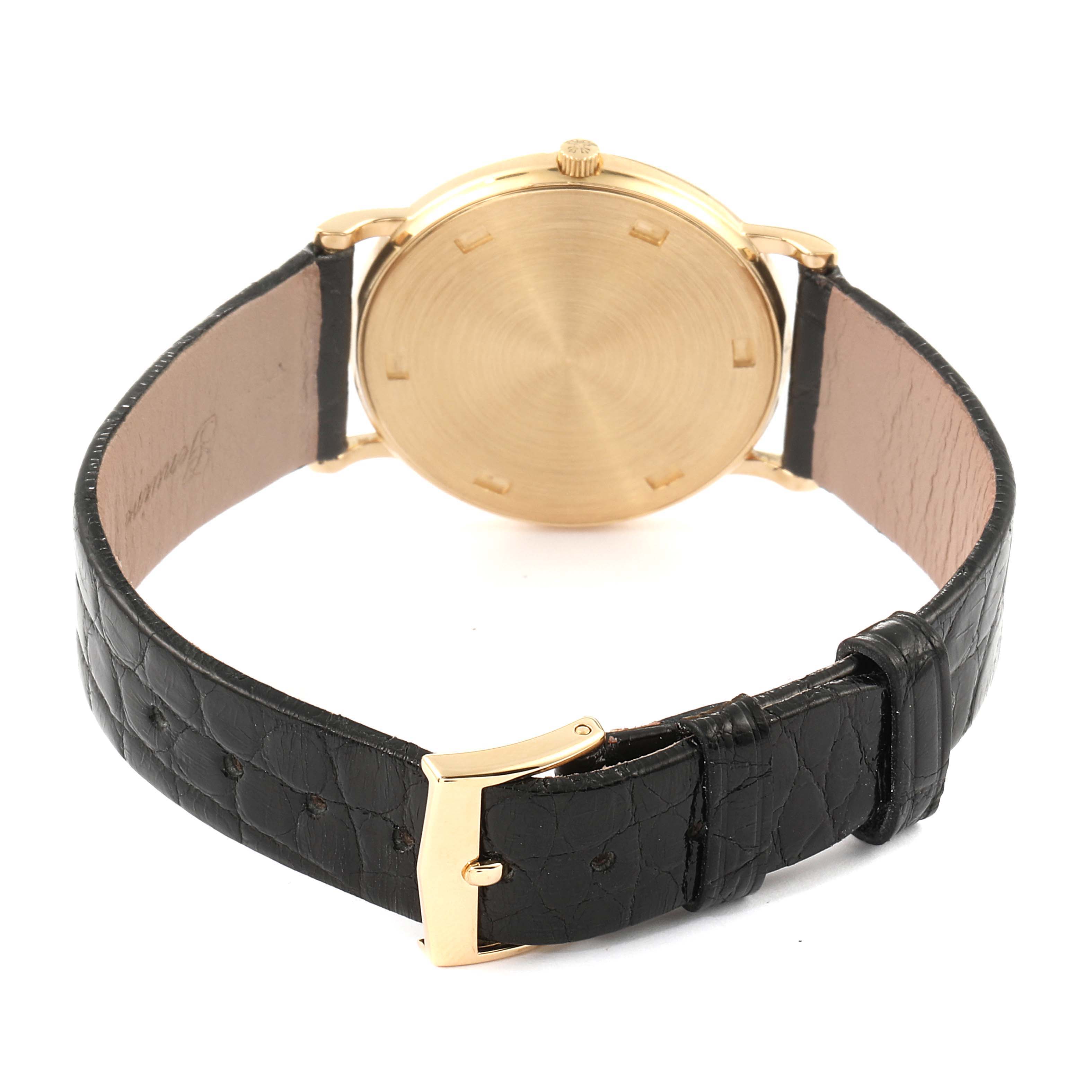 The image shows the back view of the Patek Philippe Calatrava 3520 Men's Yellow Gold White Dial 3520 Men's Yellow Gold White Dial watch, highlighting its gold case and black leather strap with a gold buckle.