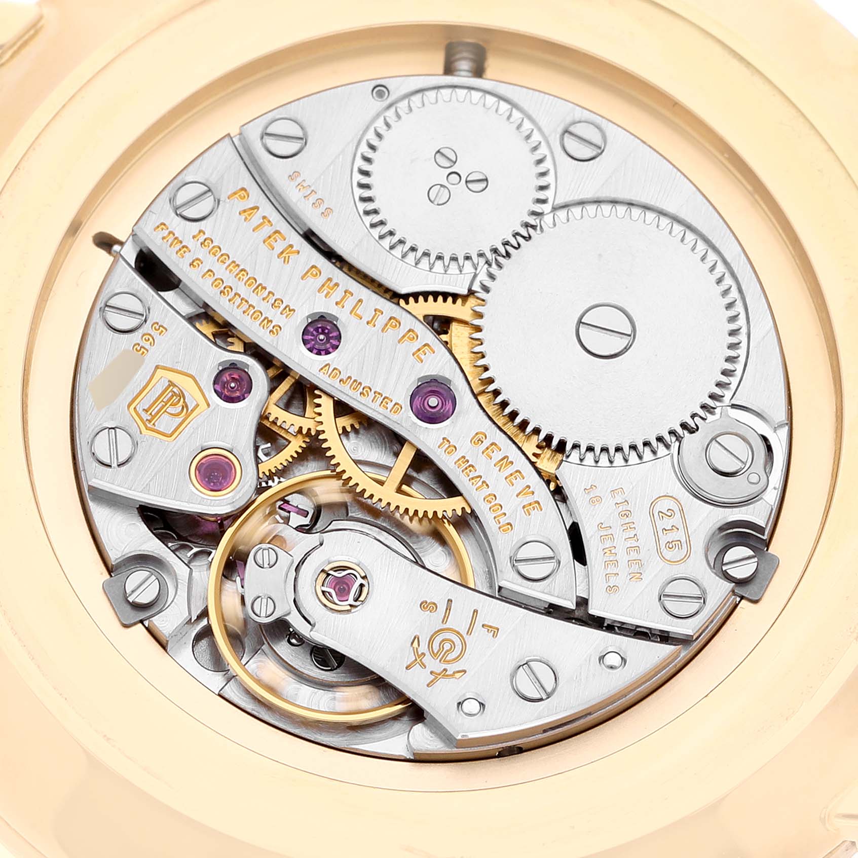 This image shows the intricate movement of the Patek Philippe Calatrava 5119J Men
s Yellow Gold White Dial 5119J Men
s Yellow Gold White Dial watch from a rear angle.