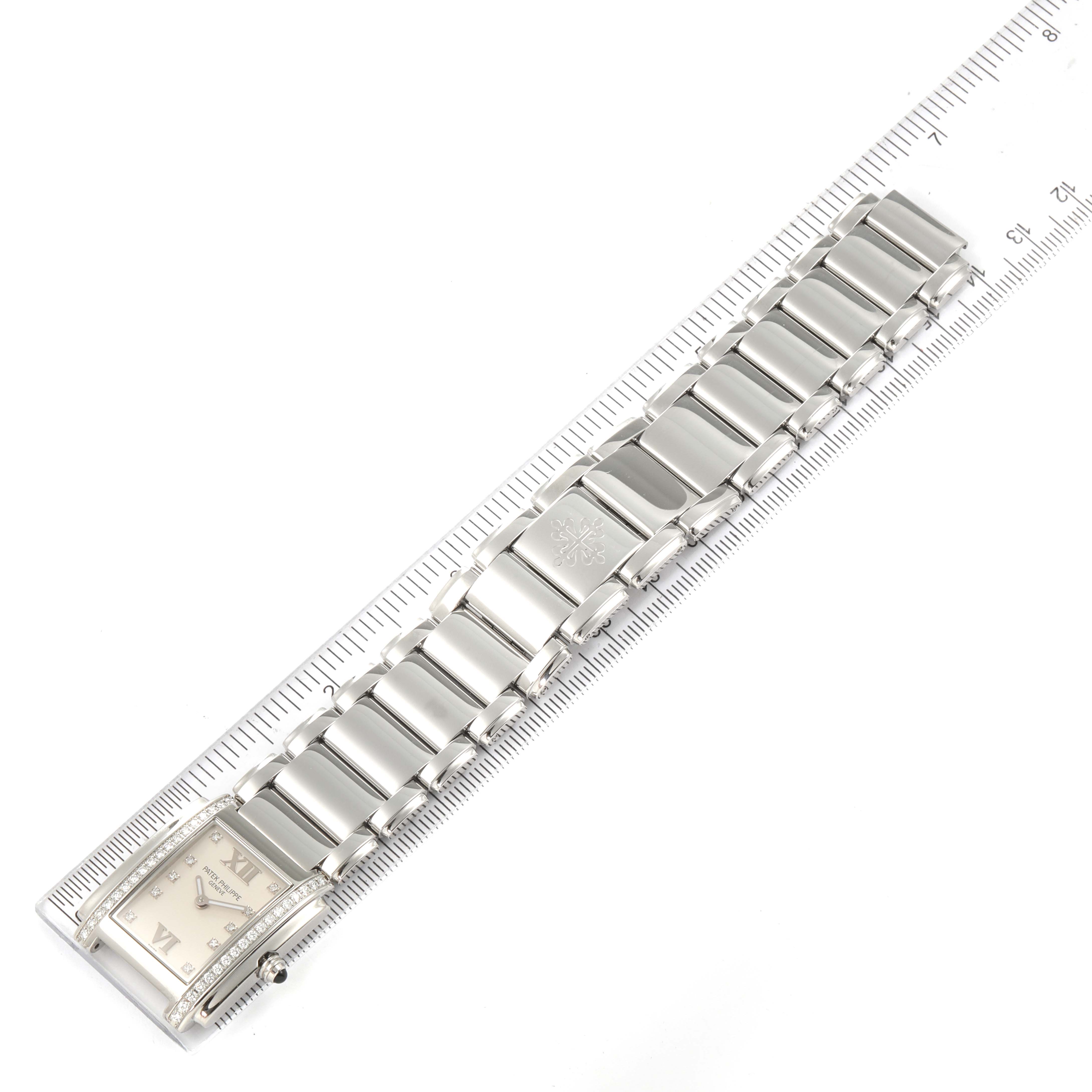 The image shows a Patek Philippe Twenty-4 4910/10A-010 Women's Stainless Steel Silver Dial 4910/10A-010 Women's Stainless Steel Silver Dial watch from a top view, highlighting the bracelet and a partial view of the face.