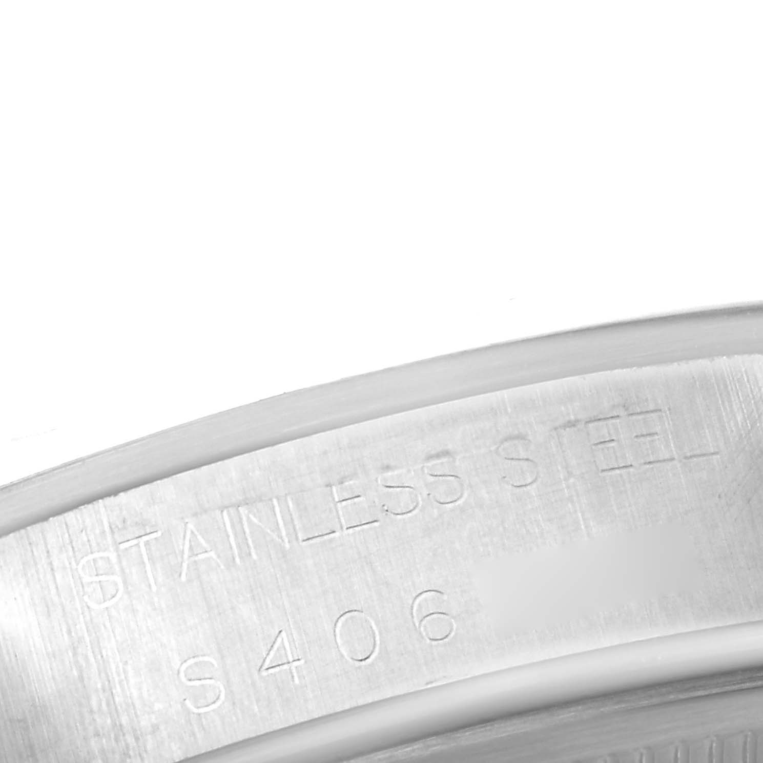 This image shows a close-up of the engraved text on the case back of a Rolex Air-King 14000 Men's Stainless Steel Blue Dial 14000 Men's Stainless Steel Blue Dial watch, highlighting the "STAINLESS STEEL" inscription.