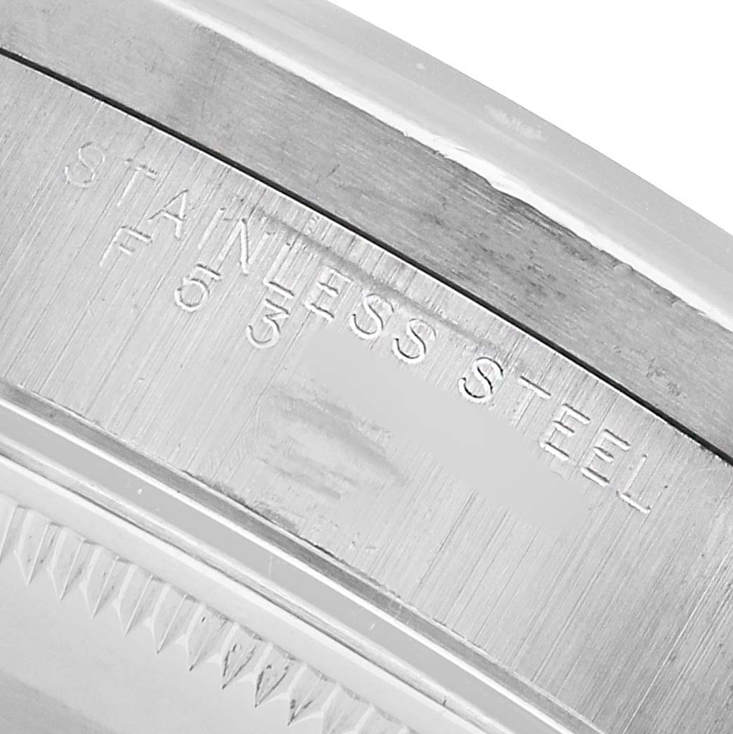 The image shows a close-up of the Rolex Air-King 14010 Men's Stainless Steel White Dial's stainless steel case with engraved text.