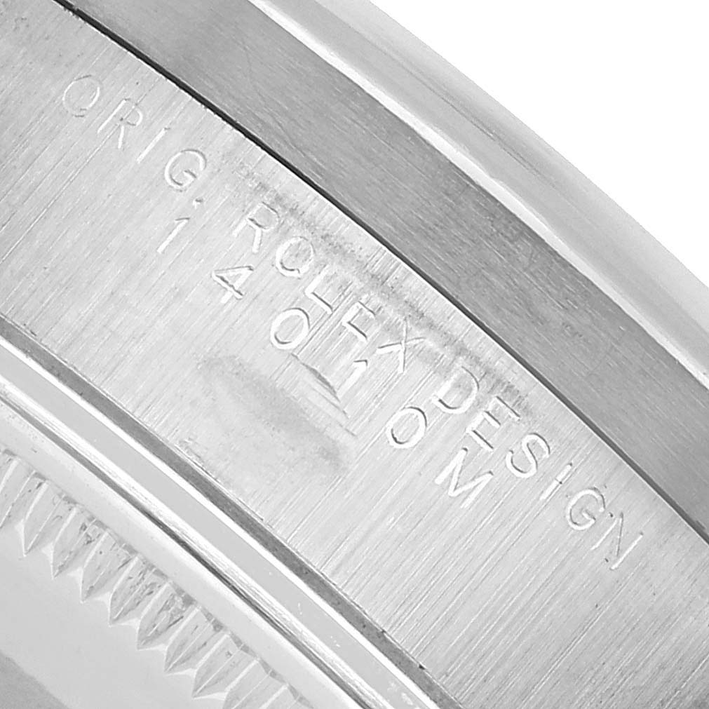 The image shows a close-up of the engraved detail on the case of a Rolex Air-King 14010 Men's Stainless Steel White Dial watch.